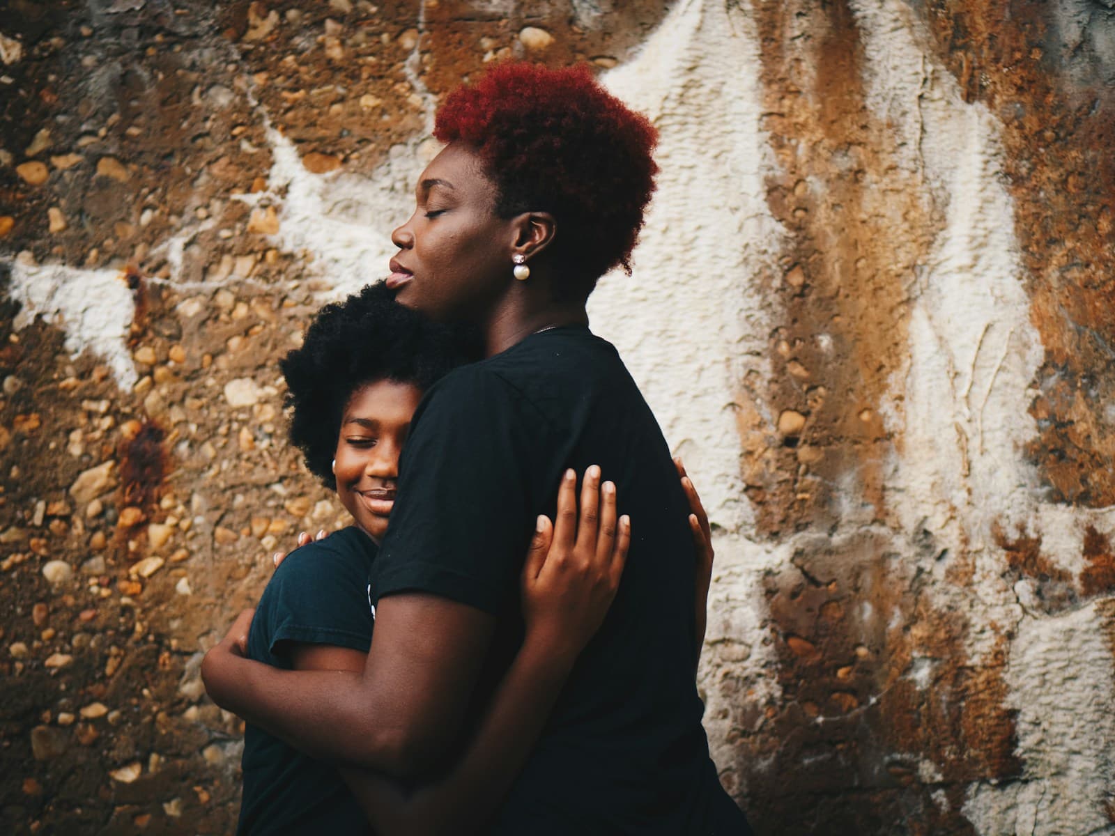 Two women holding each other in a warm hug